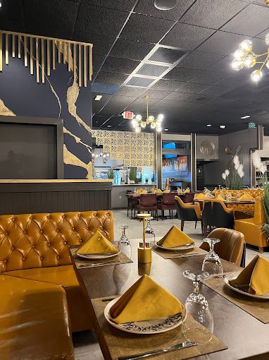 Mustard leather booths beside a navy and gold wall